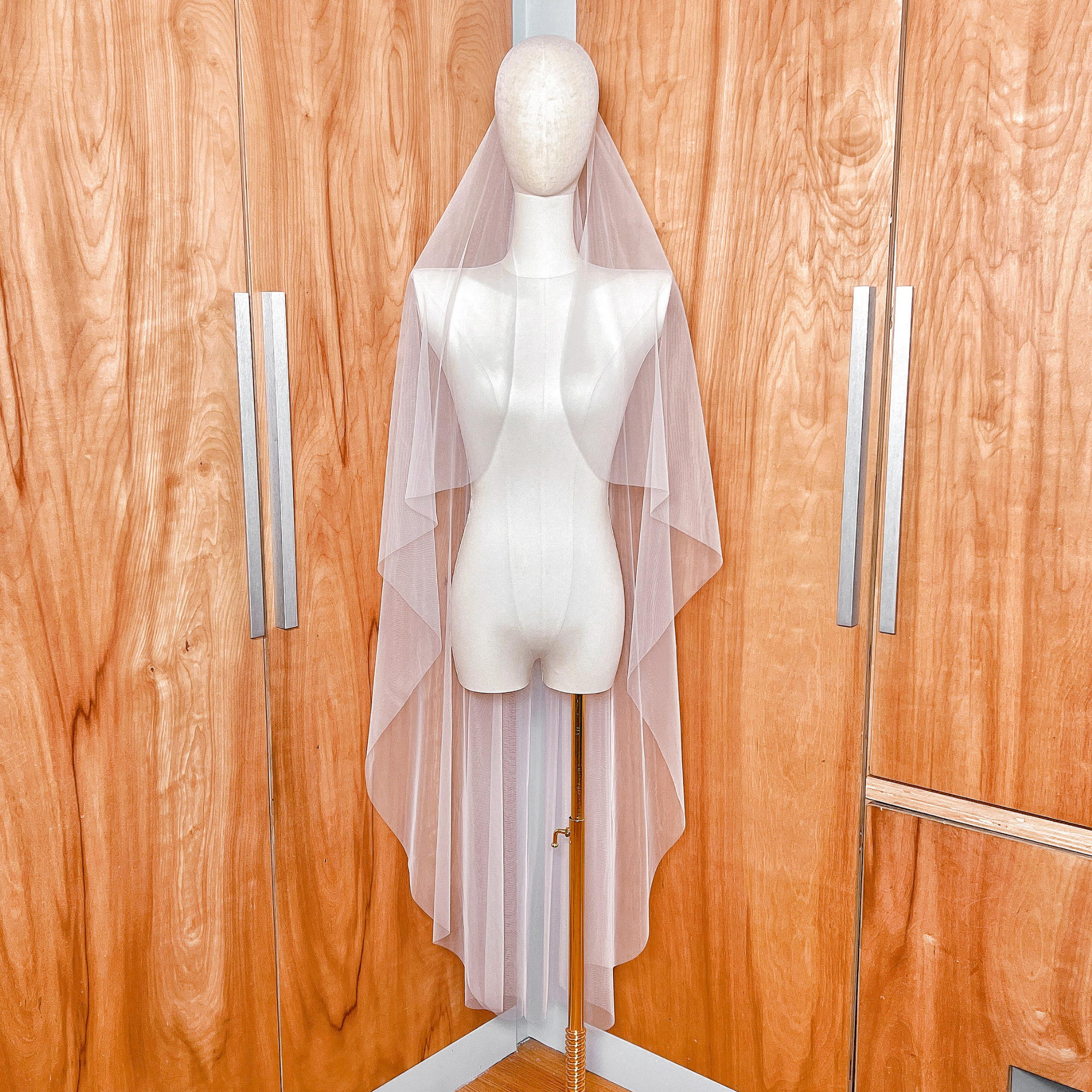 Front view of the cascade waltz length wedding veil with a clean raw edge finish.
