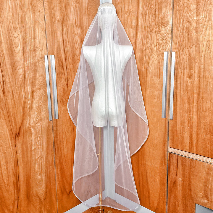 Back view of a cascade waltz wedding veil with 1/2" horsehair trim, showing how the tulle falls gracefully to the knee.