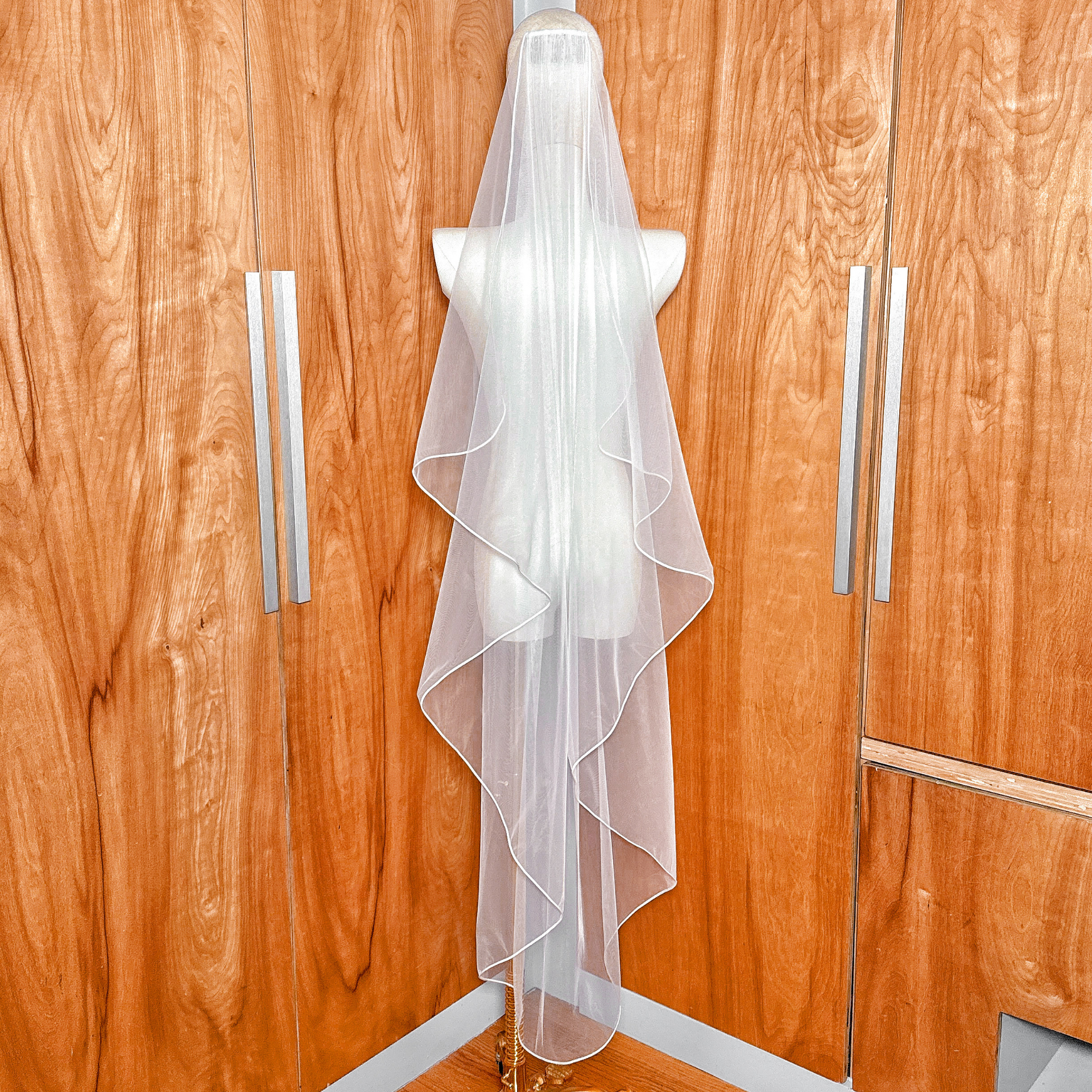 Rear angle view displaying the layered cascading effect of the Cascade Waltz Wedding Veil with Corded Edge.