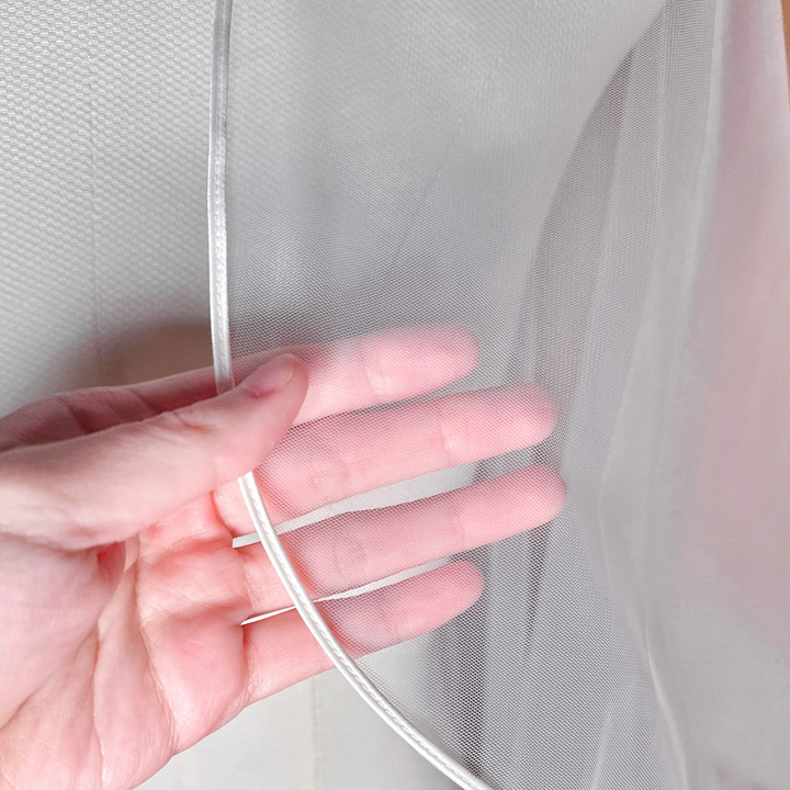 Macro shot demonstrating the sheer fabric quality and corded border of the Cascade Waltz Wedding Veil with Corded Edge.