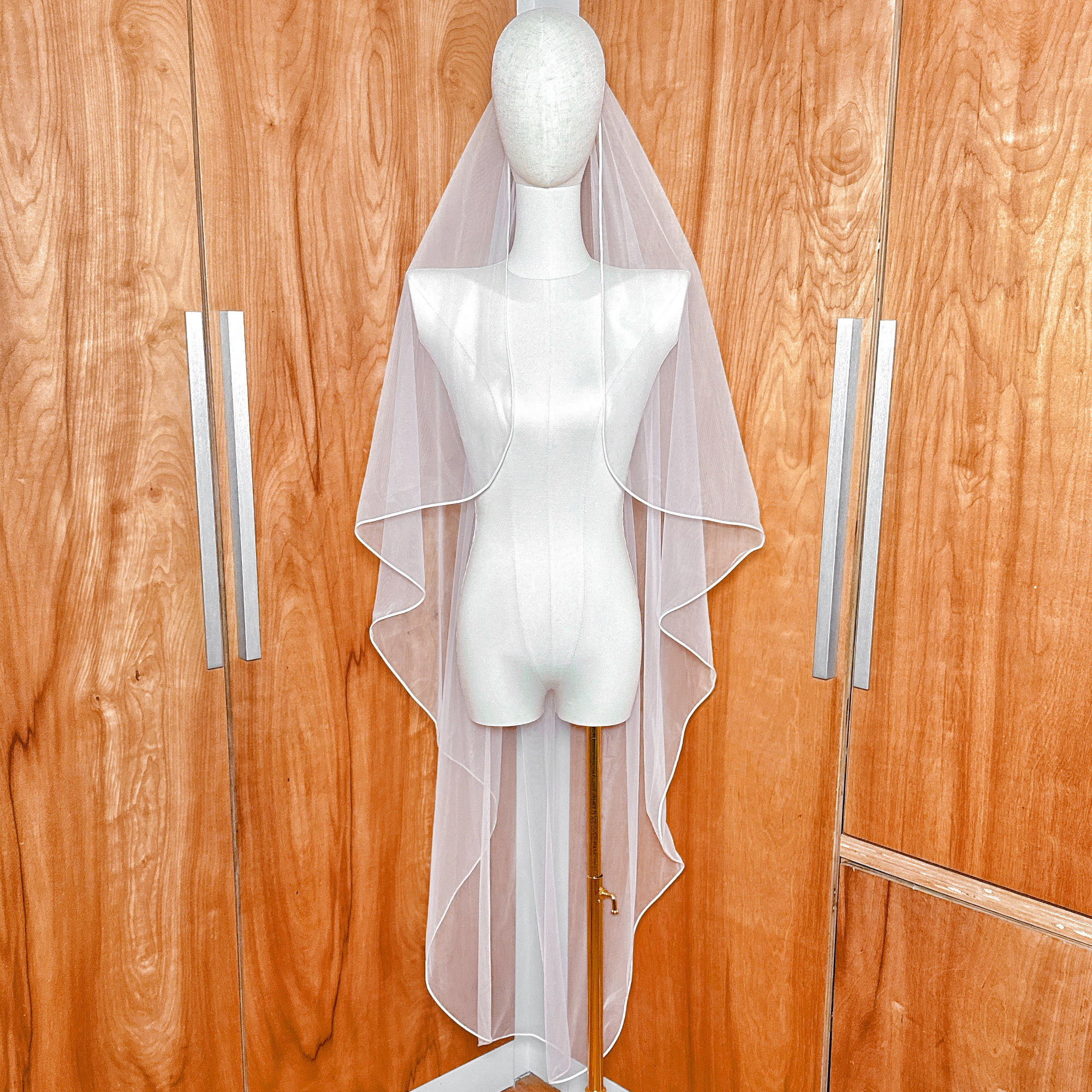 Front view of Cascade Waltz Wedding Veil with Corded Edge highlighting the intricate bridal tulle drape.