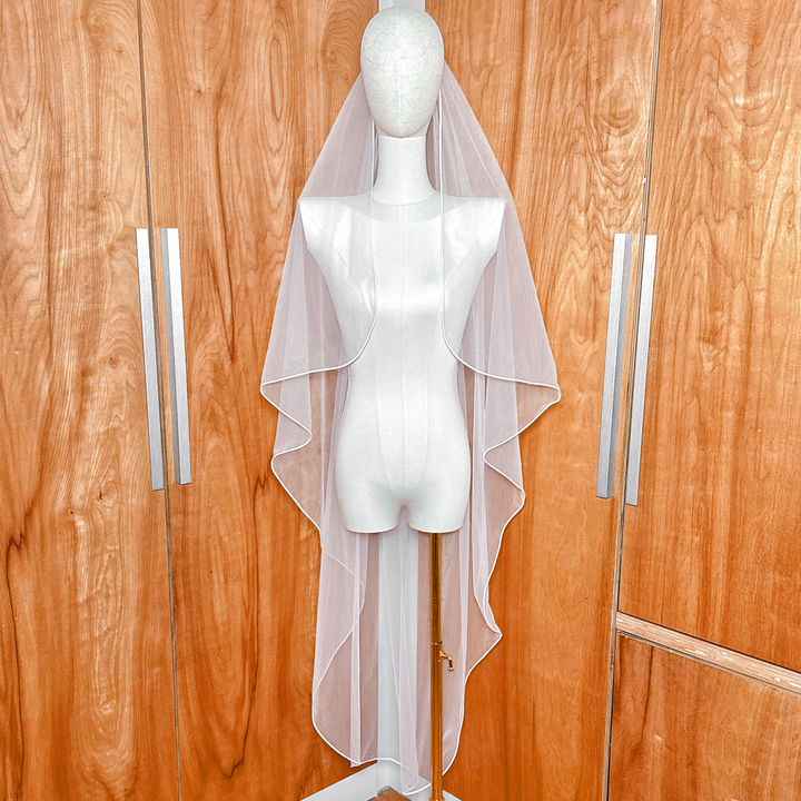 Front view of Cascade Waltz Wedding Veil with Corded Edge highlighting the intricate bridal tulle drape.