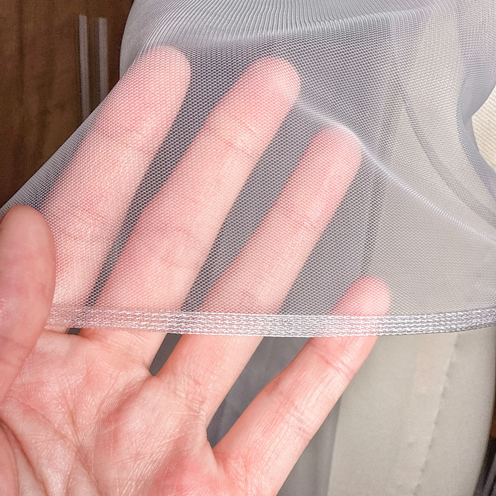 Close-up of the 1/8 inch horsehair trim on a white cascade wedding veil shown in cathedral length on a mannequin.