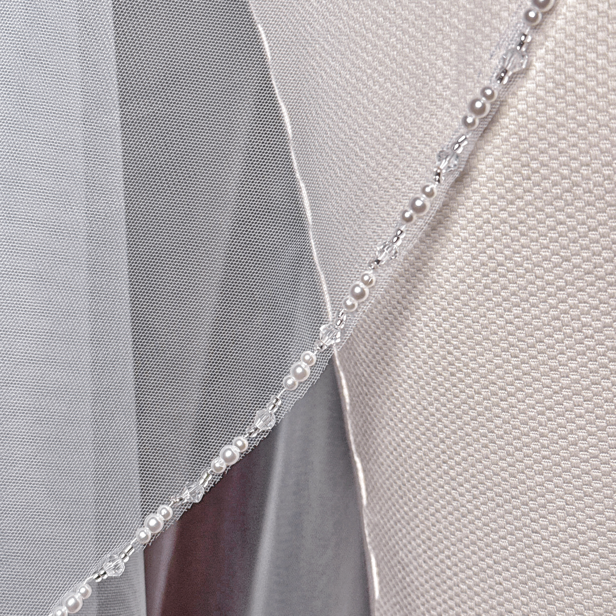 Elegant cathedral length wedding veil with cascading beaded edges for a bridal look.