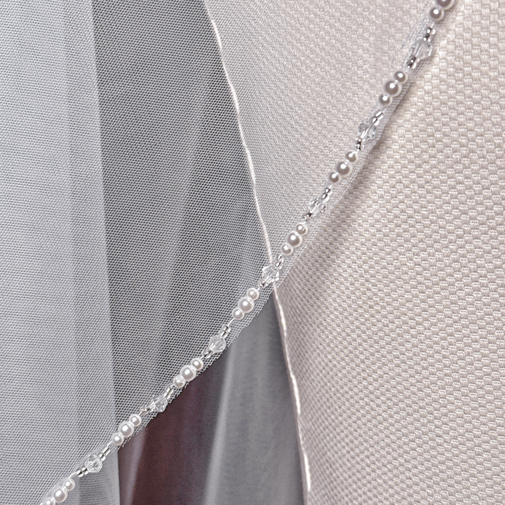 Elegant cathedral length wedding veil with cascading beaded edges for a bridal look.