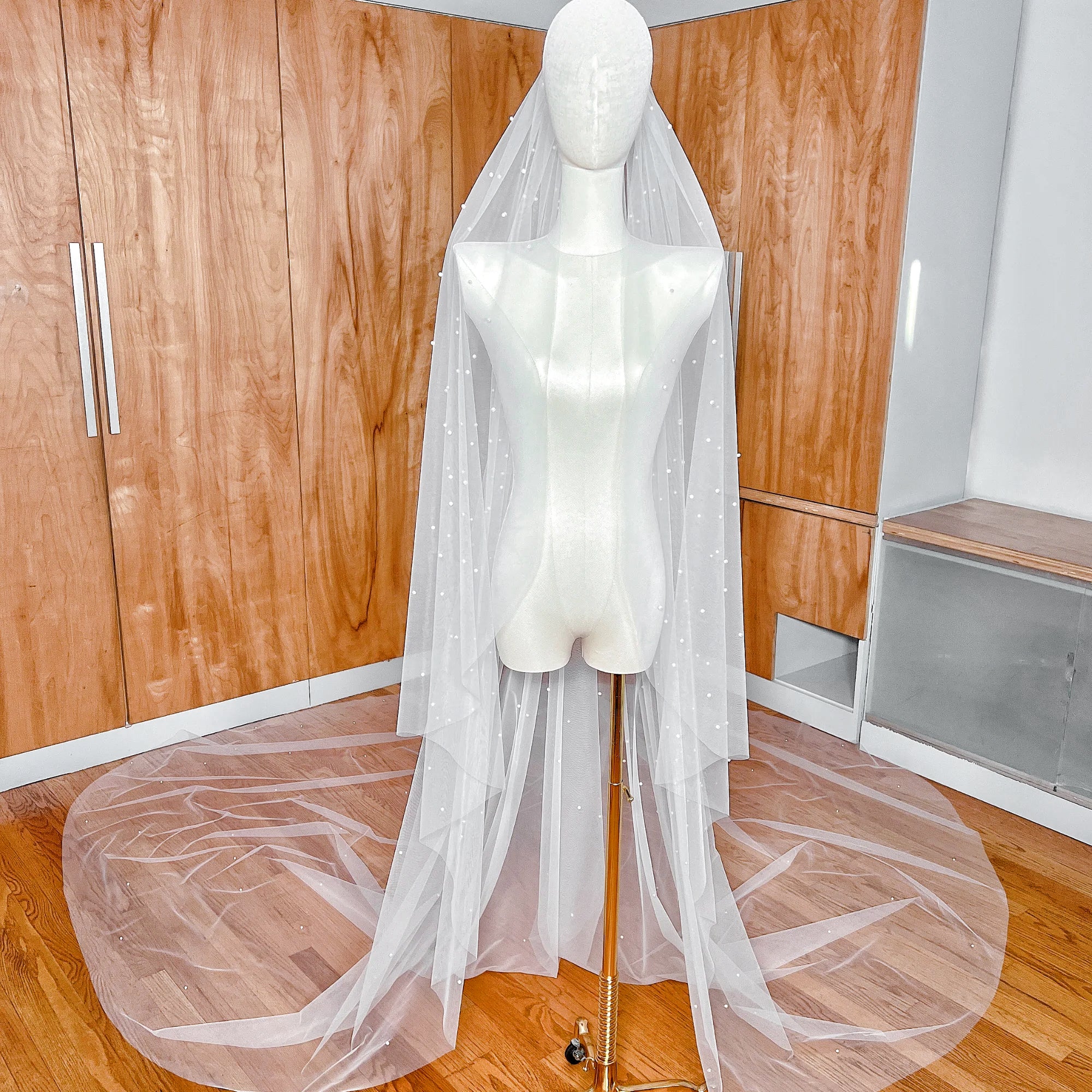 Royal cathedral length cascading scattered pearl wedding veil draped elegantly to show full 144-inch span.