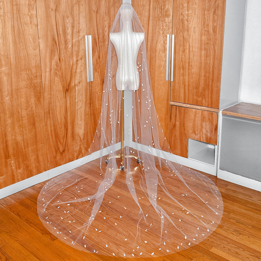 Back view of the 3D silk petal veil in cathedral length cascading down a mannequin.