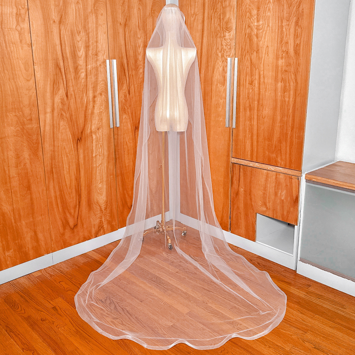 Back view of a cathedral length cascade wedding veil featuring a structured 1.5 inch horsehair edge.