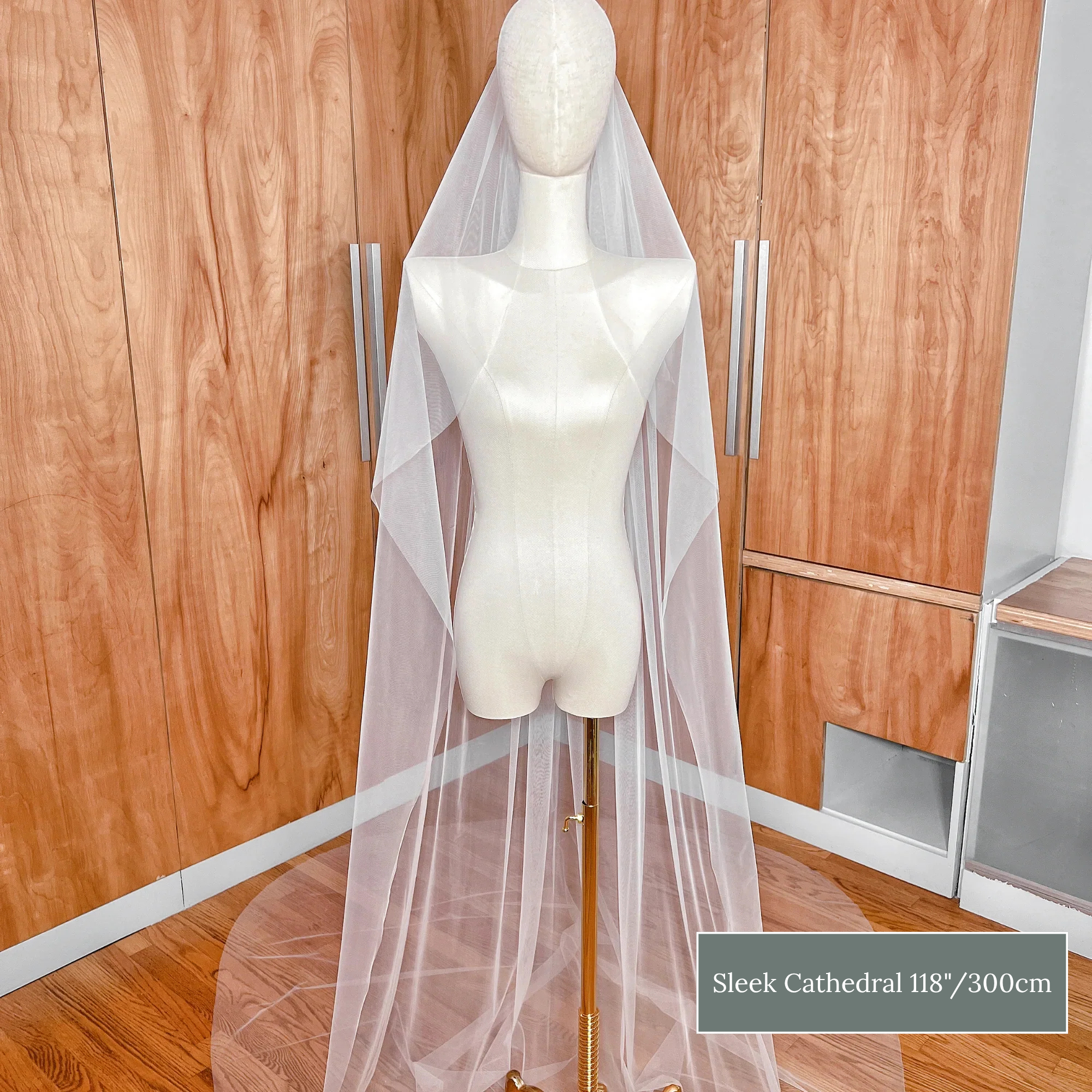 Dramatic cathedral length raw edge cascade wedding veil with a long flowing waterfall effect.