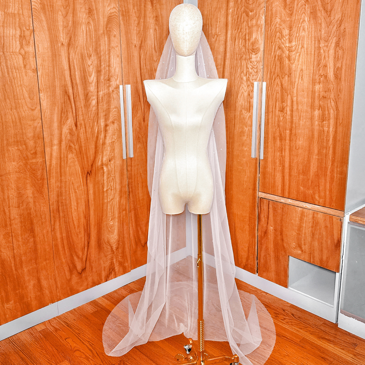 Sheer bridal tulle fabric of a scattered rhinestone mantilla wedding veil.