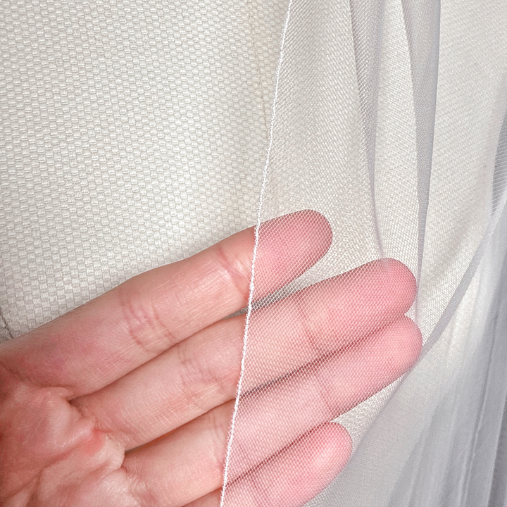 Close-up of the delicate tulle and finished border on a simple pencil edge wedding veil.