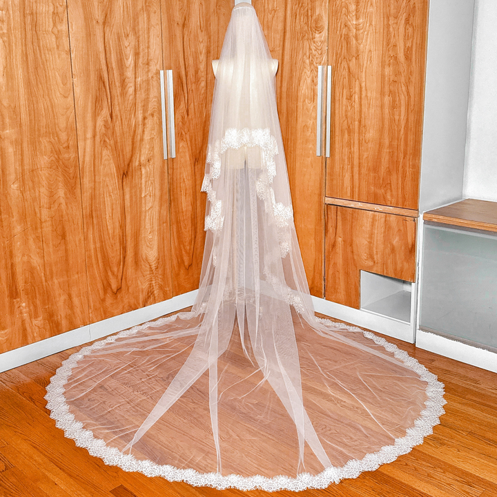 Back view of a cathedral length Two Tier Chantilly Lace Wedding Veil on a mannequin, highlighting the full 118-inch drape.