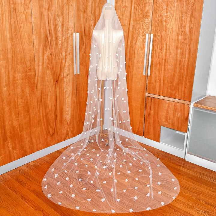 Back view of a cathedral length two tier 3D floral wedding veil with blusher on a mannequin.