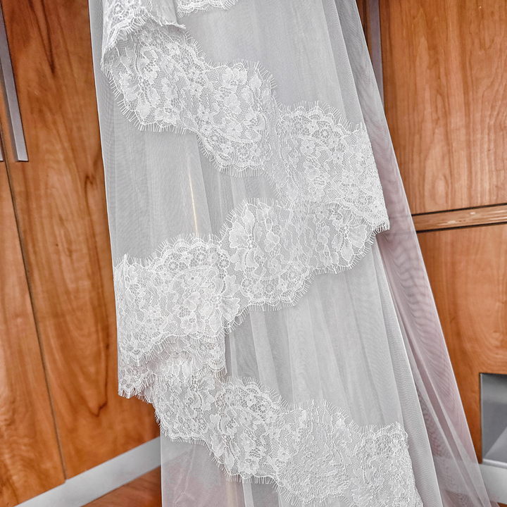 Cathedral wedding veil with a wide Chantilly lace edge and soft tulle blusher.
