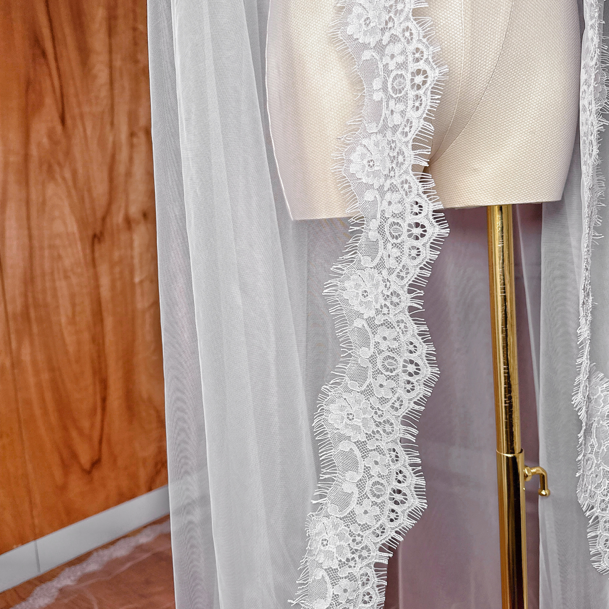 Close-up of the intricate French Chantilly lace scalloped edge on a cathedral length mantilla veil.