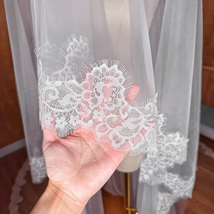 Close-up of the delicate Chantilly lace trim on a two tier cathedral length bridal veil.