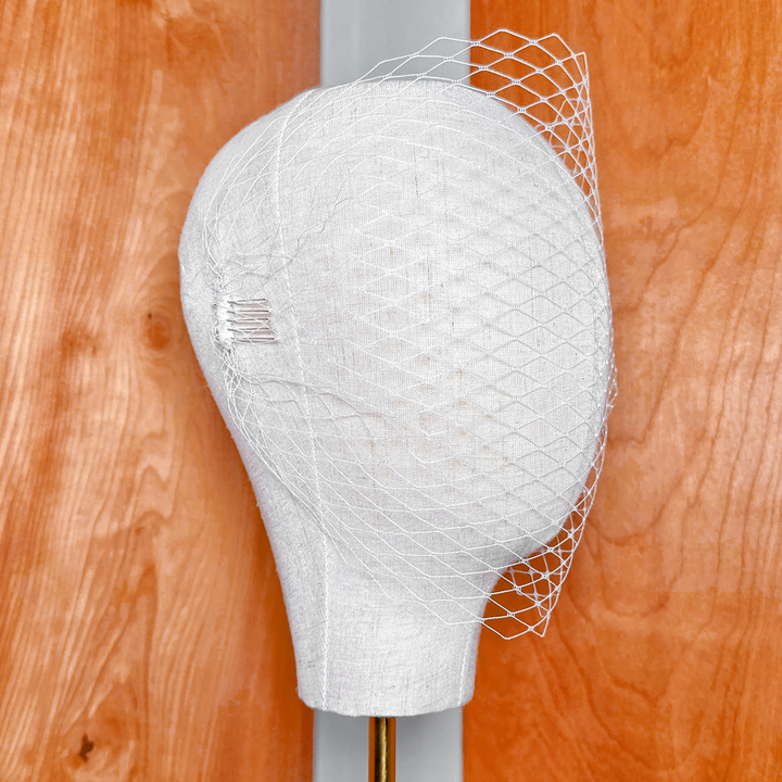Close-up of the fine netting on a classic bandeau birdcage wedding veil.