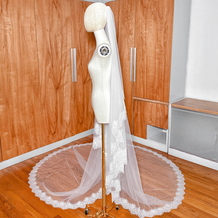 Classic cathedral length Two Tier Chantilly Lace Wedding Veil pinned to a mannequin to demonstrate the waterfall drape effect.