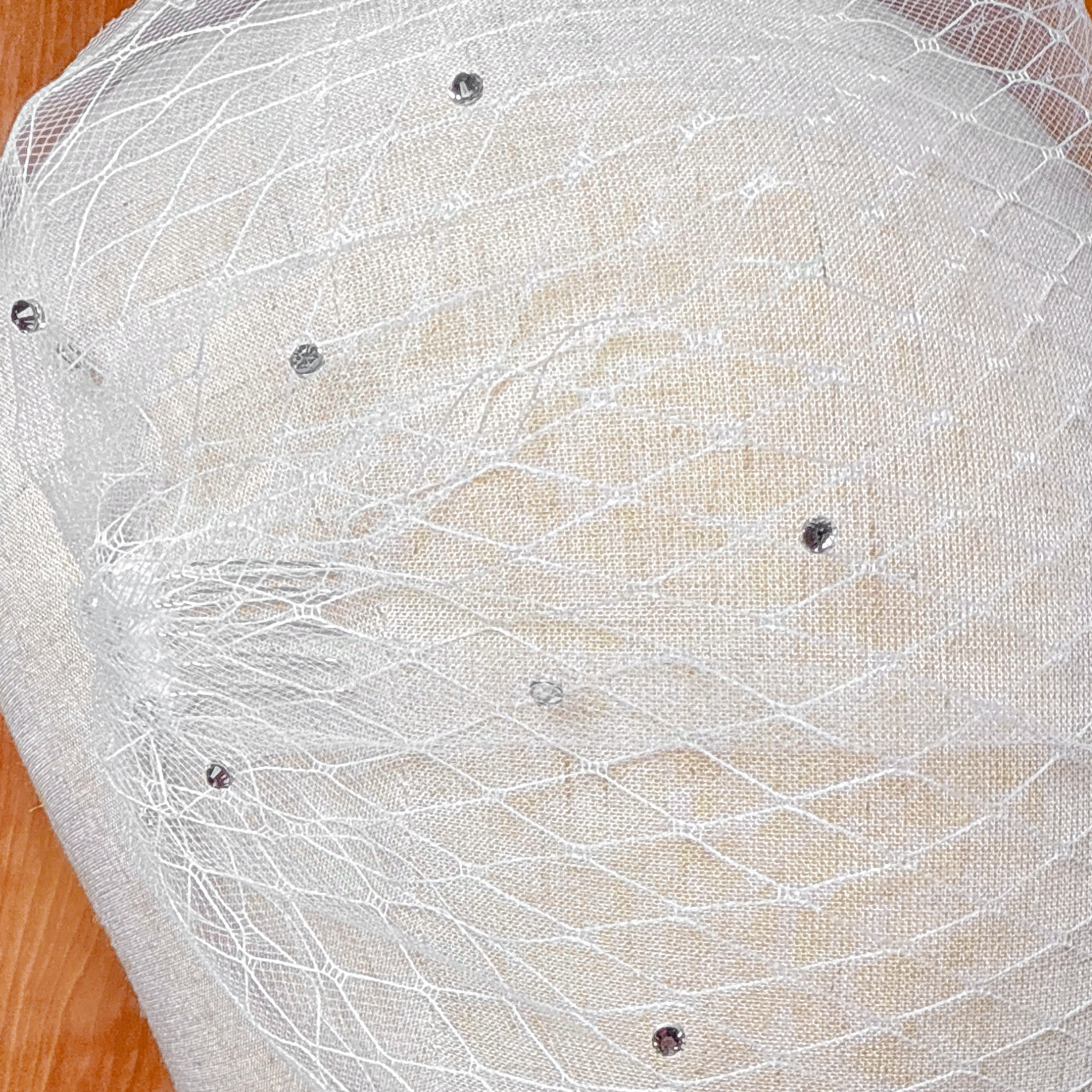 Close-up shot of the rhinestone embellishments on a double layer bandeau wedding veil.