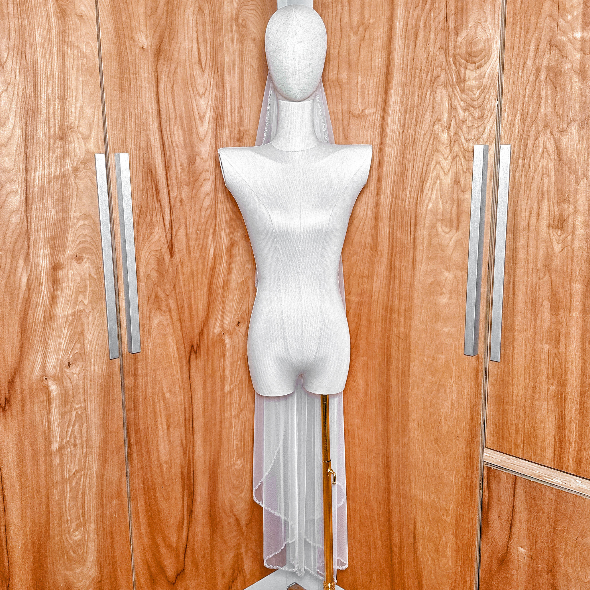 Waltz length crystal beaded edge wedding veil displayed on a bridal mannequin.