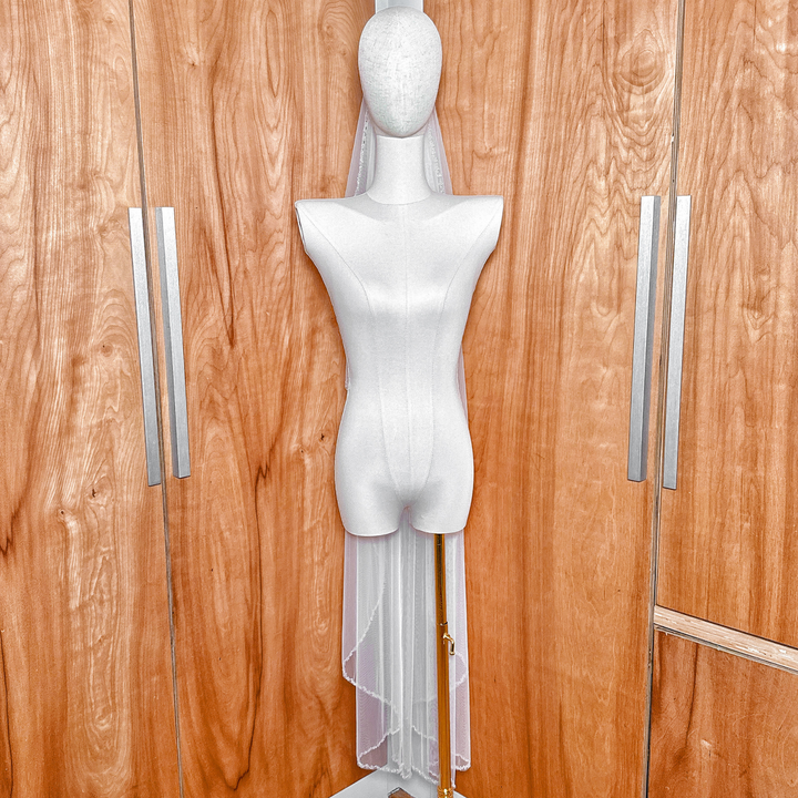 Waltz length crystal beaded edge wedding veil displayed on a bridal mannequin.