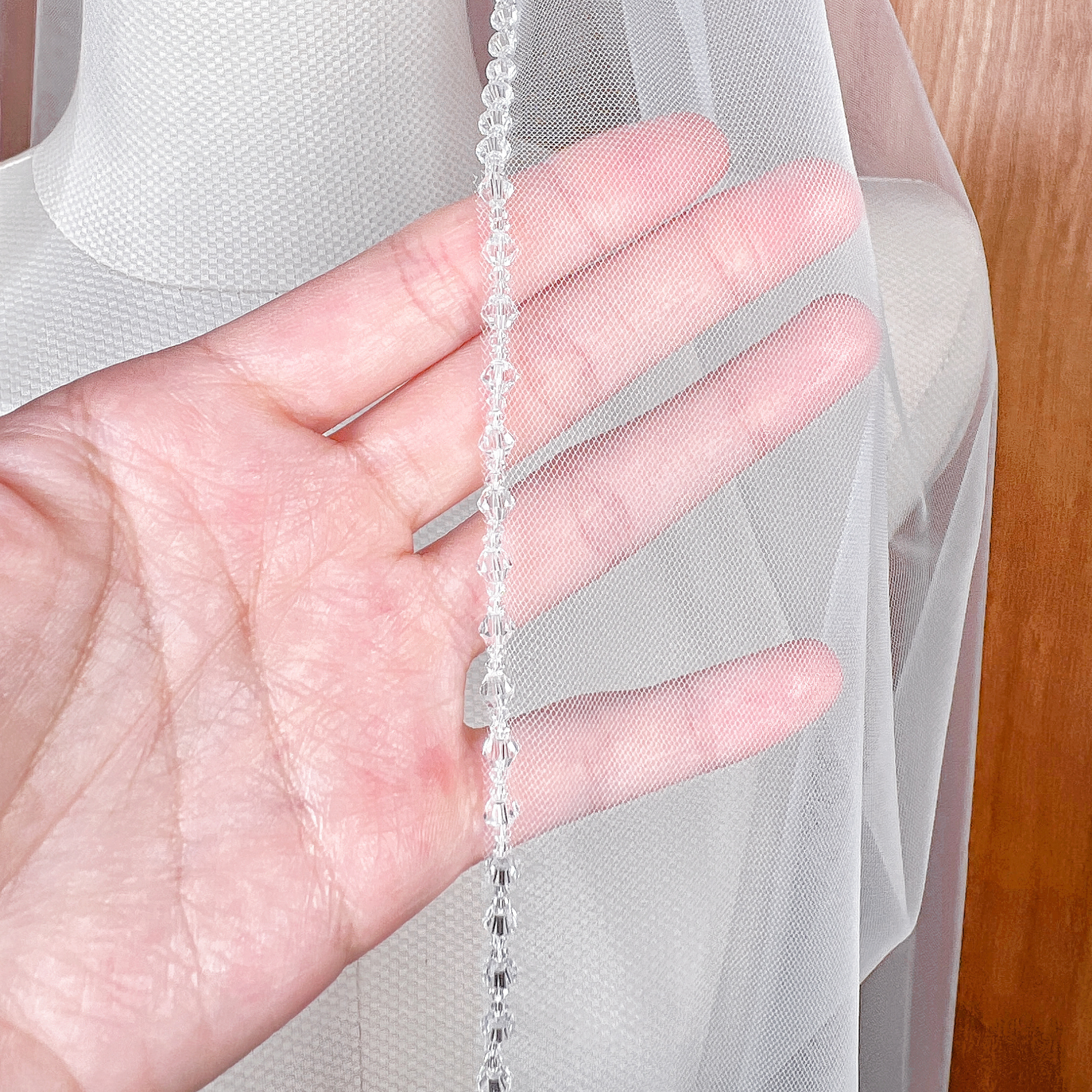 Close-up shot of the intricate rhinestone border on a crystal edge wedding veil.