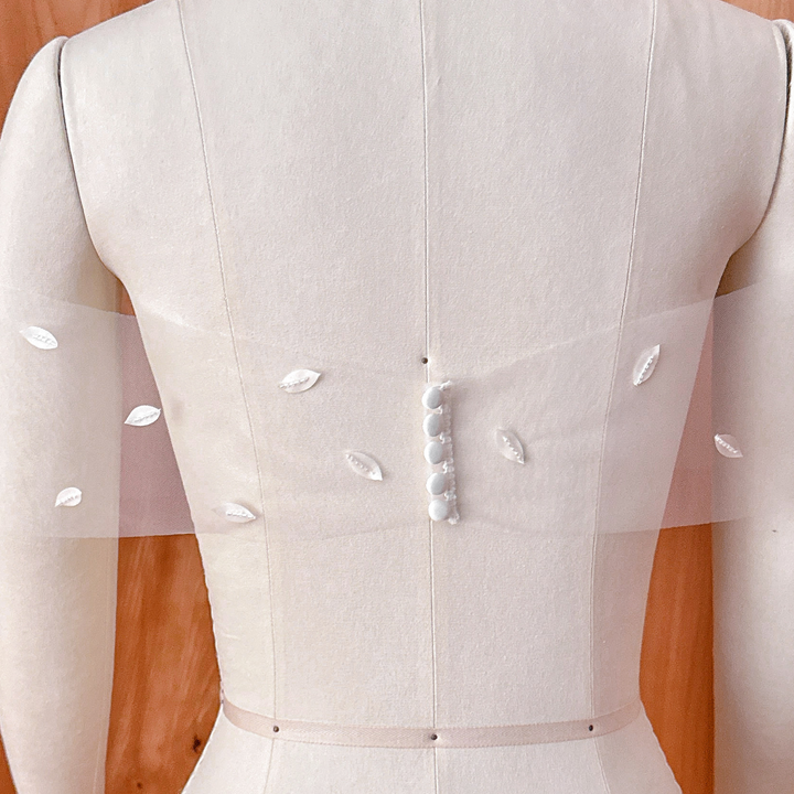 Premium handcrafted 3D silk petal detachable illusion wrap for a romantic 2-in-1 look.