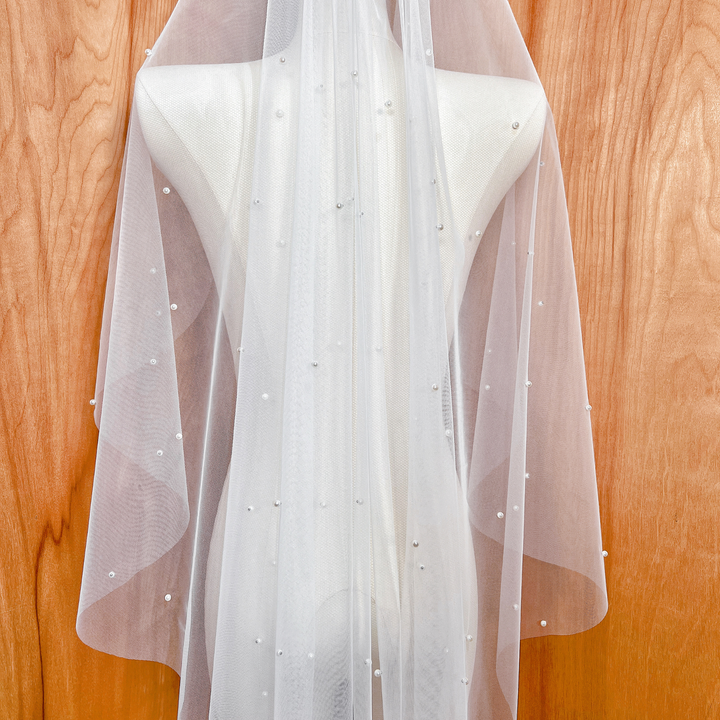 Close-up of the delicate pearl embellishments on a cascading scattered pearl wedding veil.
