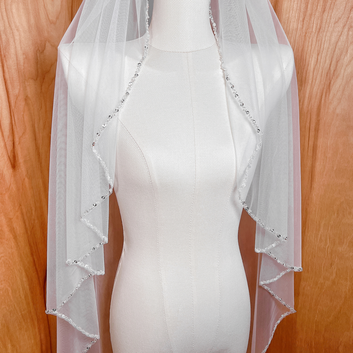 Detailed view of the beaded edge wedding veil.