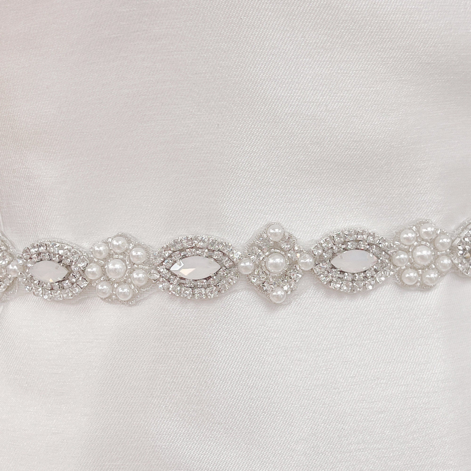 Close-up detail of the hand-stitched pearls and rhinestones on the Vintage Art Deco beaded wedding belt.