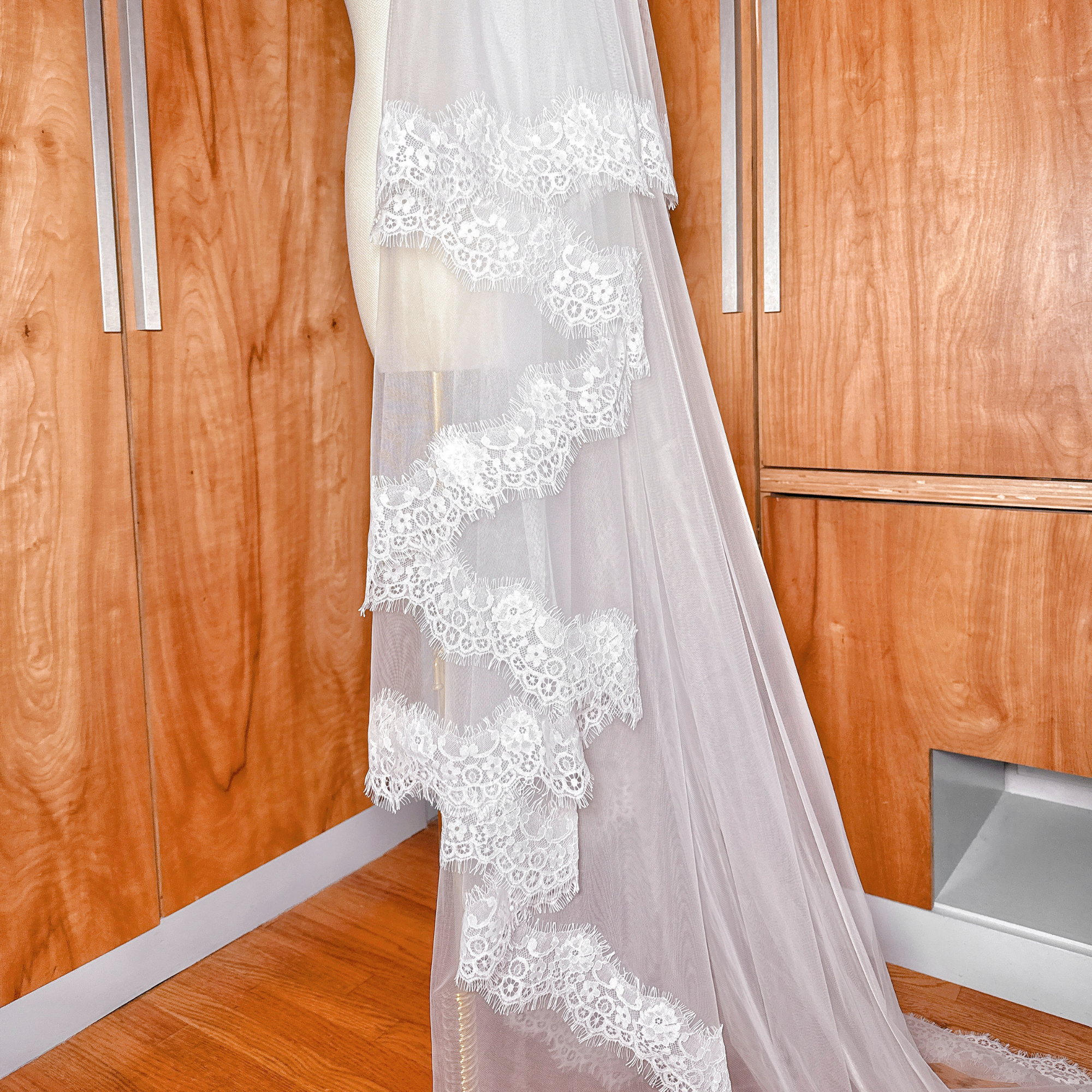 Close shot of the eyelash lace edging on a cathedral length Two Tier Chantilly Lace Wedding Veil.