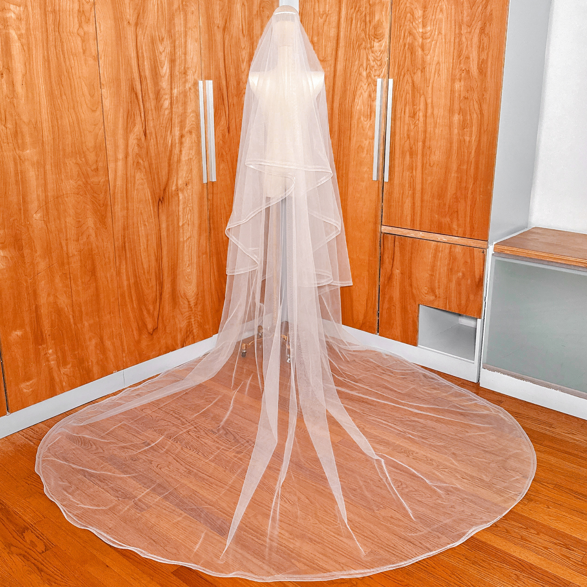 Back view of a cathedral length double horsehair wedding veil on a mannequin.