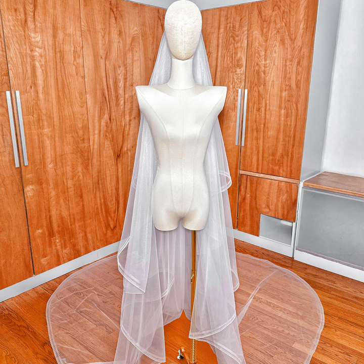 Sheer cathedral length double horsehair wedding veil featuring a wide horsehair trim.