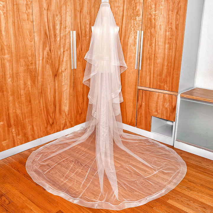 Sheer bridal tulle of a cathedral length double horsehair wedding veil on a bridal mannequin.