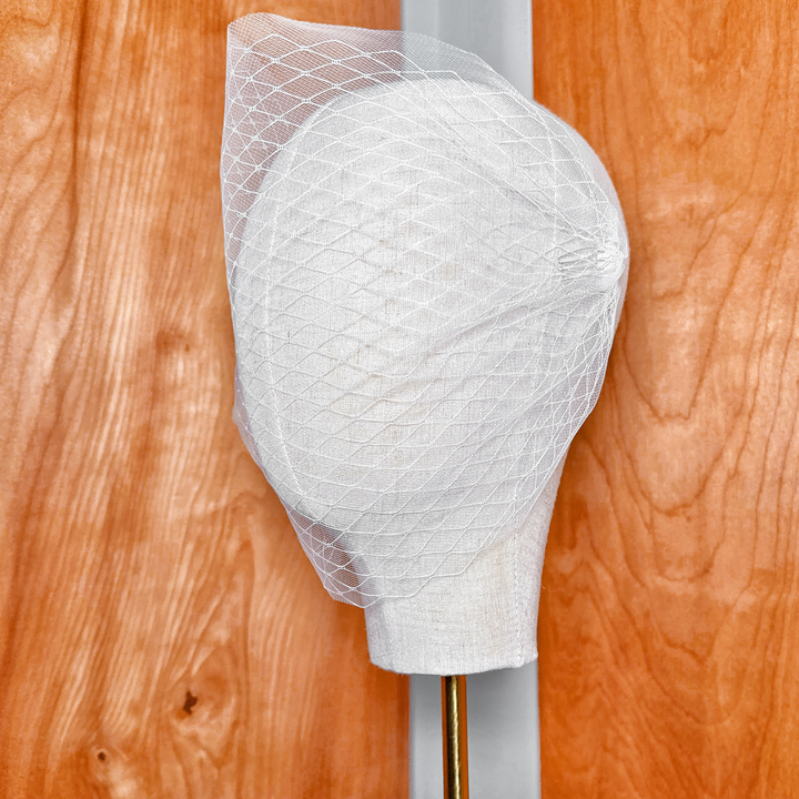 Side profile view of a double layer bandeau wedding veil showing the distinct tiered lengths and volume.