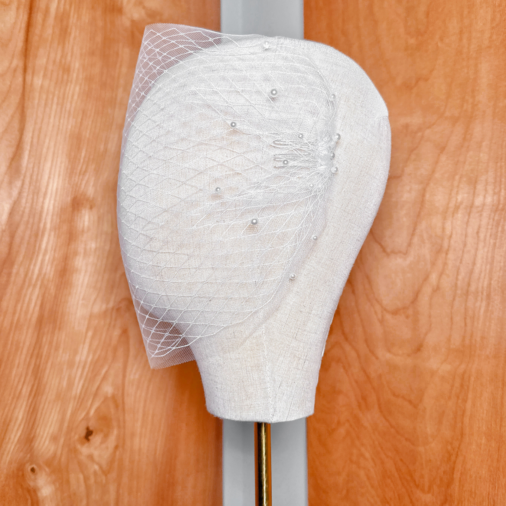 Rear perspective of the Double Layer Bandeau Wedding Veil with Pearls showcasing the drape and cascading sheer fabric layers.