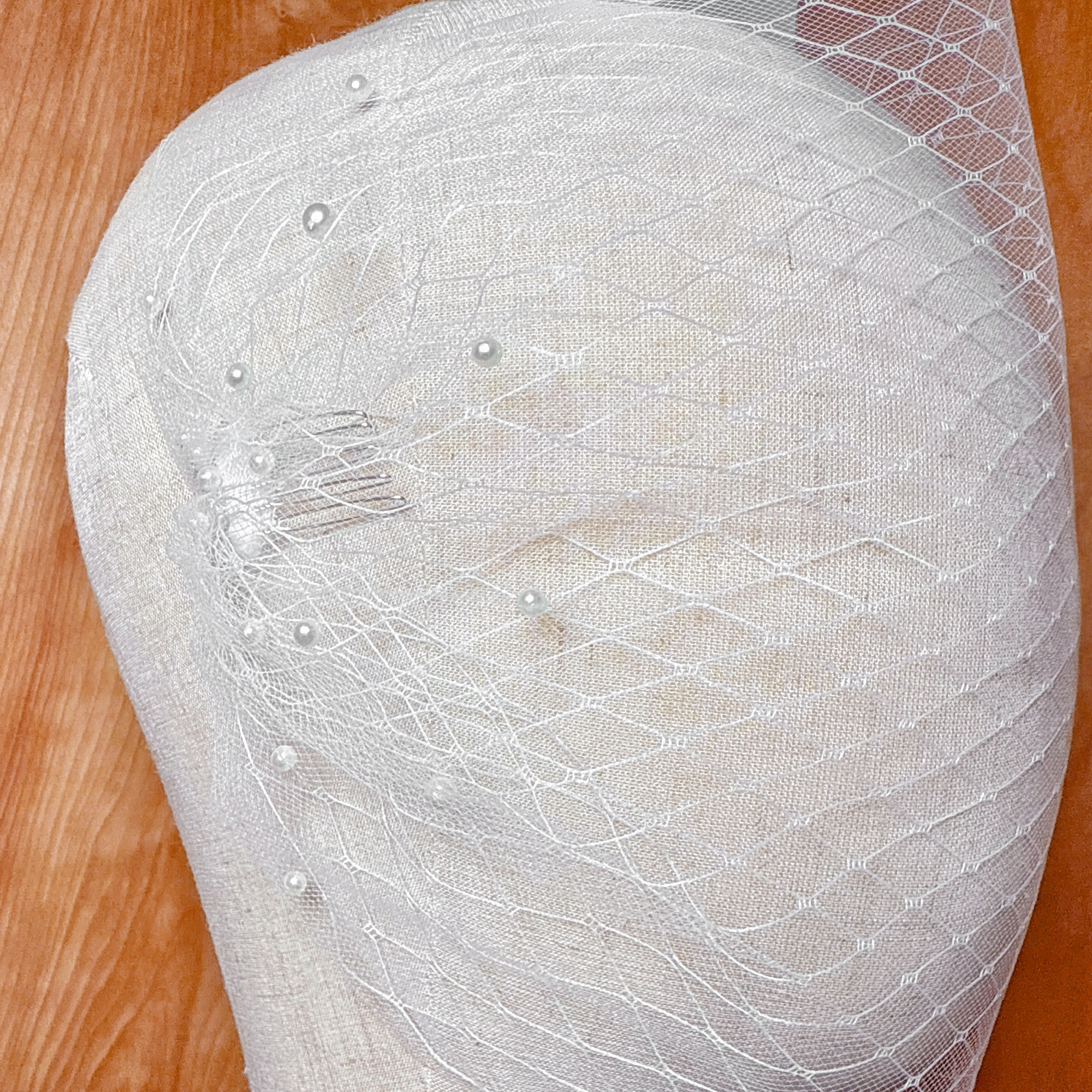 Double Layer Bandeau Wedding Veil with Pearls displayed on a bridal mannequin showing the sheer tulle layers and delicate pearl embellishments.