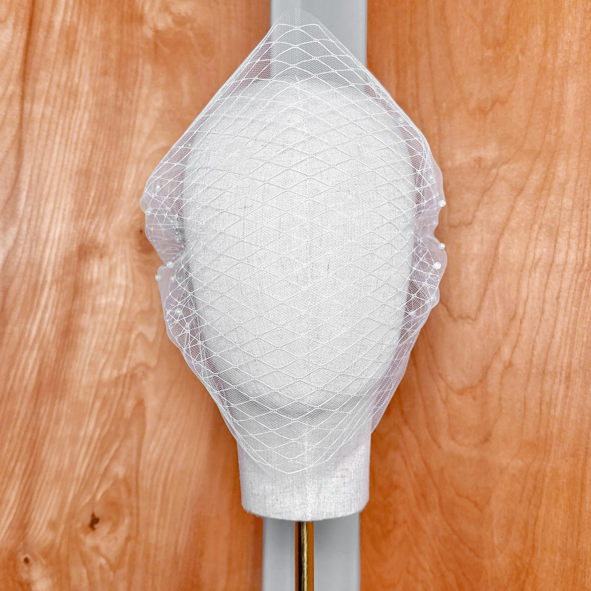 High-resolution texture shot demonstrating the premium sheer tulle material of the Double Layer Bandeau Wedding Veil with Pearls.
