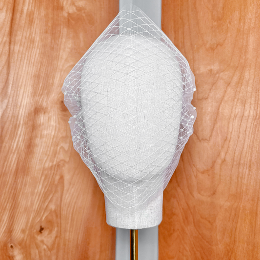 High-resolution texture shot demonstrating the premium sheer tulle material of the Double Layer Bandeau Wedding Veil with Pearls.