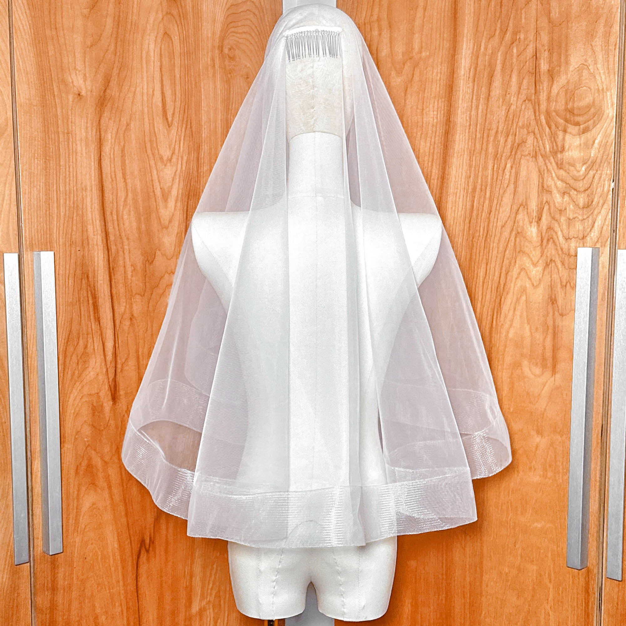 Rear view of the 2 1/2 inch horsehair trim on a two tier elbow length wedding veil with blusher.
