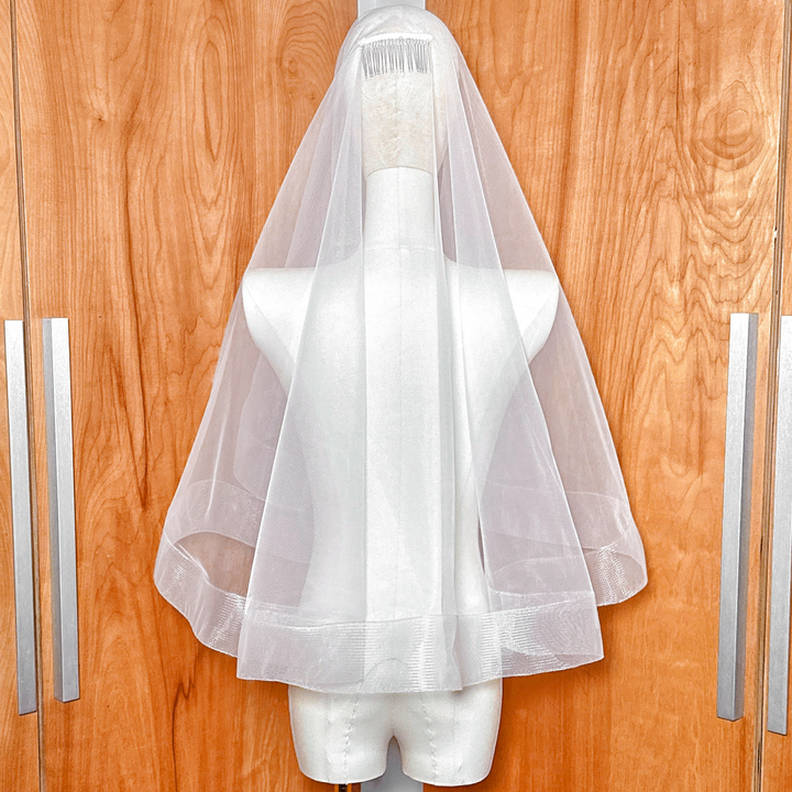 Rear view of the 2 1/2 inch horsehair trim on a two tier elbow length wedding veil with blusher.