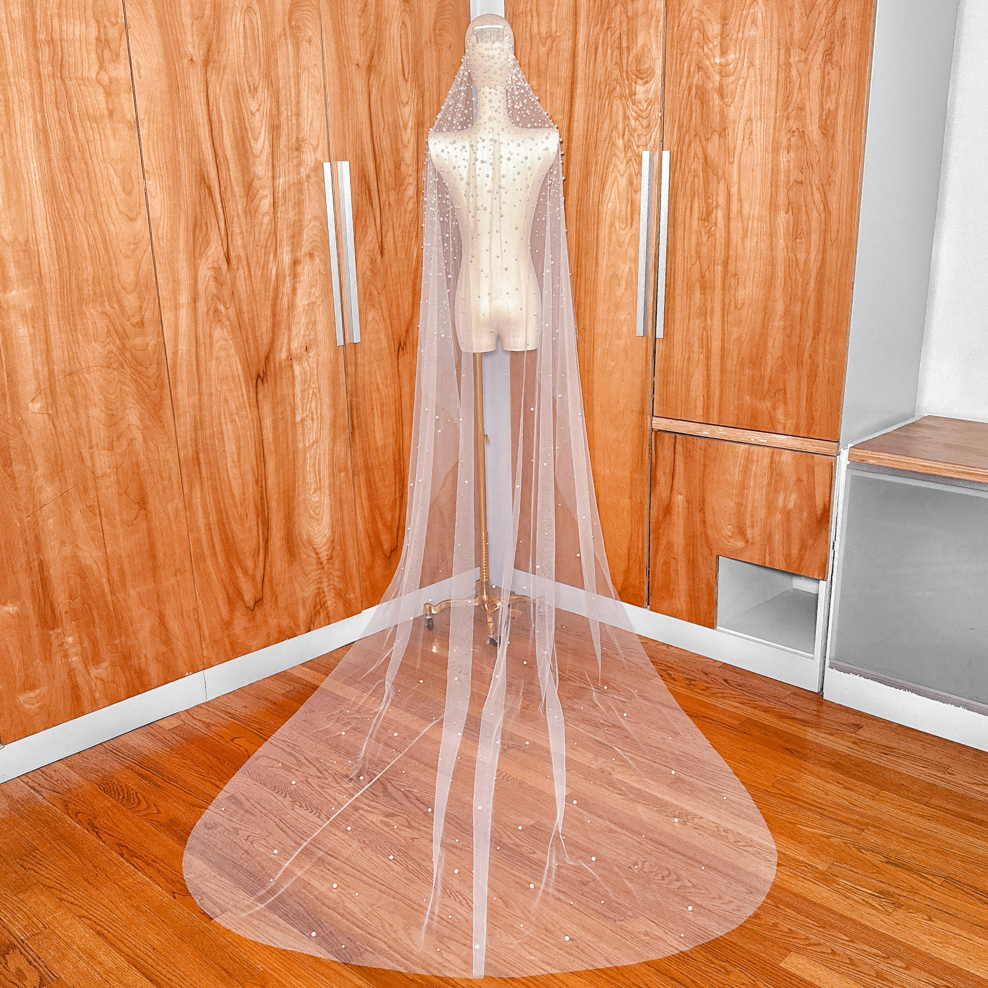 Elegant ivory pearl studded mantilla wedding veil in cathedral length for a classic bridal look.