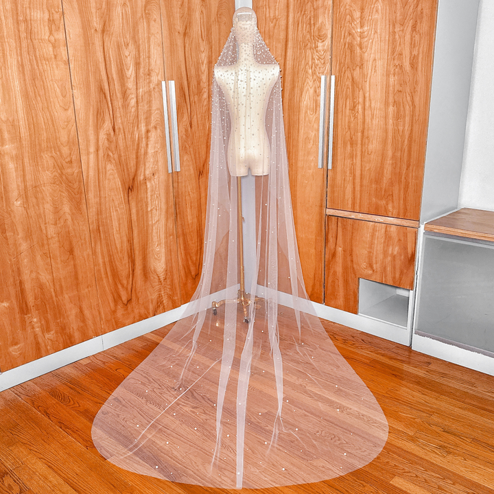Elegant ivory pearl studded mantilla wedding veil in cathedral length for a classic bridal look.