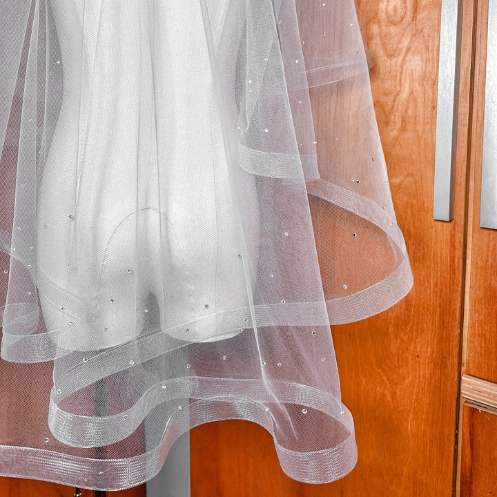 Fingertip length bridal accessory featuring a two tier horsehair wedding veil with scattered rhinestones.