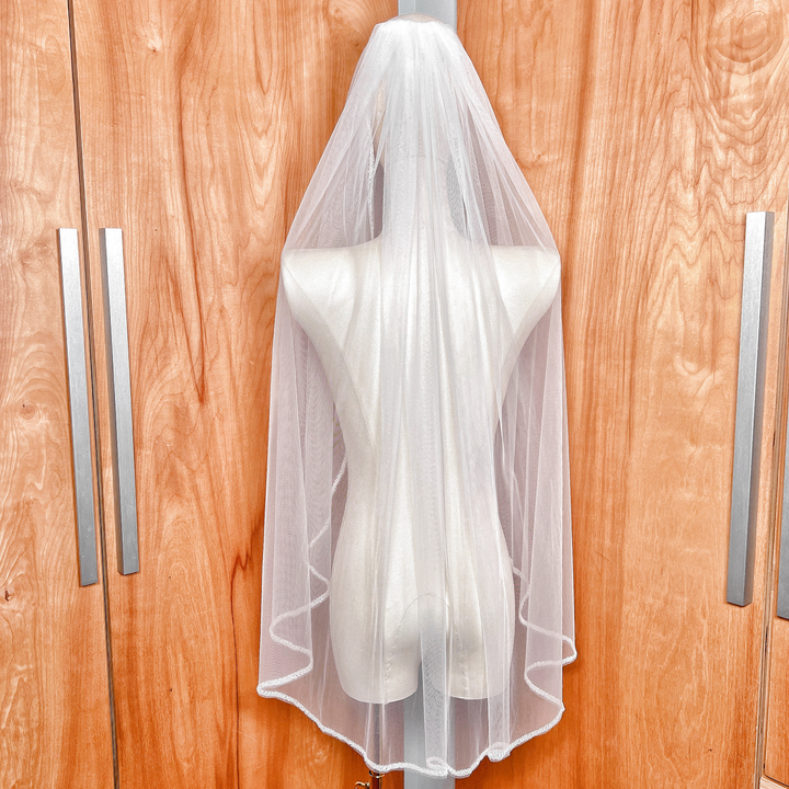 Back view of a fingertip length beaded edge wedding veil with frosted bugle beads.