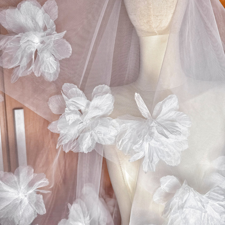 Close-up of the intricate floral appliqués on a two tier 3D flower wedding veil.
