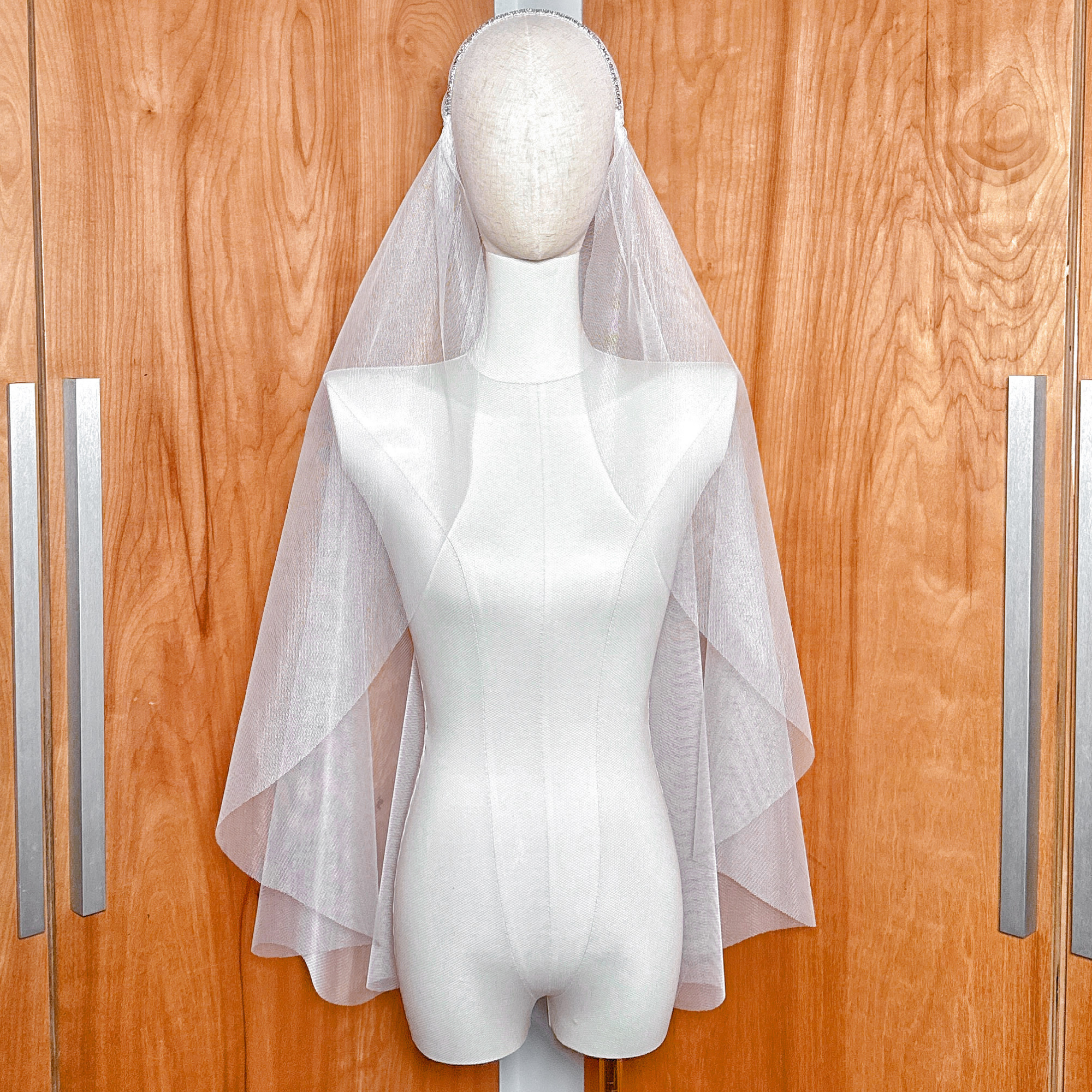 Fingertip length beaded Juliet cap veil displayed on a mannequin head.