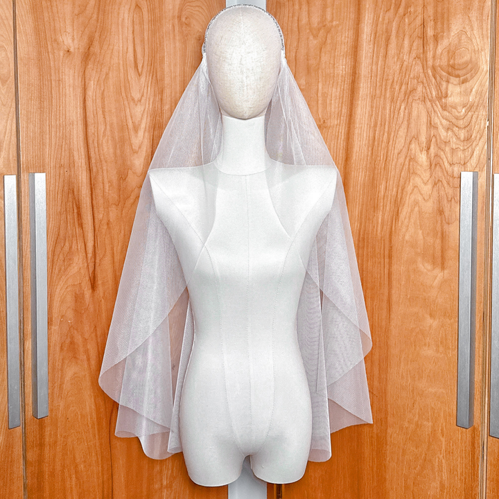 Fingertip length beaded Juliet cap veil displayed on a mannequin head.