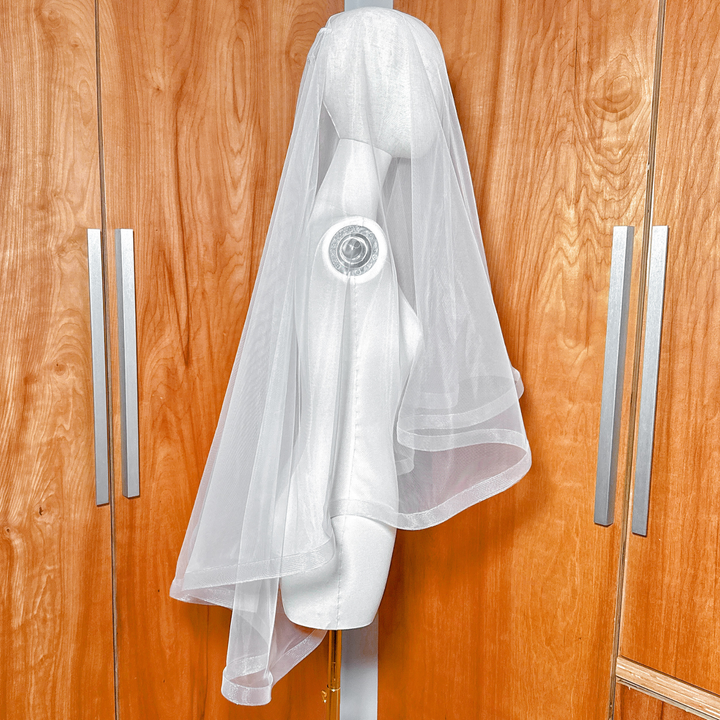 Side view of a 1 1/2" horsehair trim wedding veil with blusher on a mannequin showing the fingertip length.