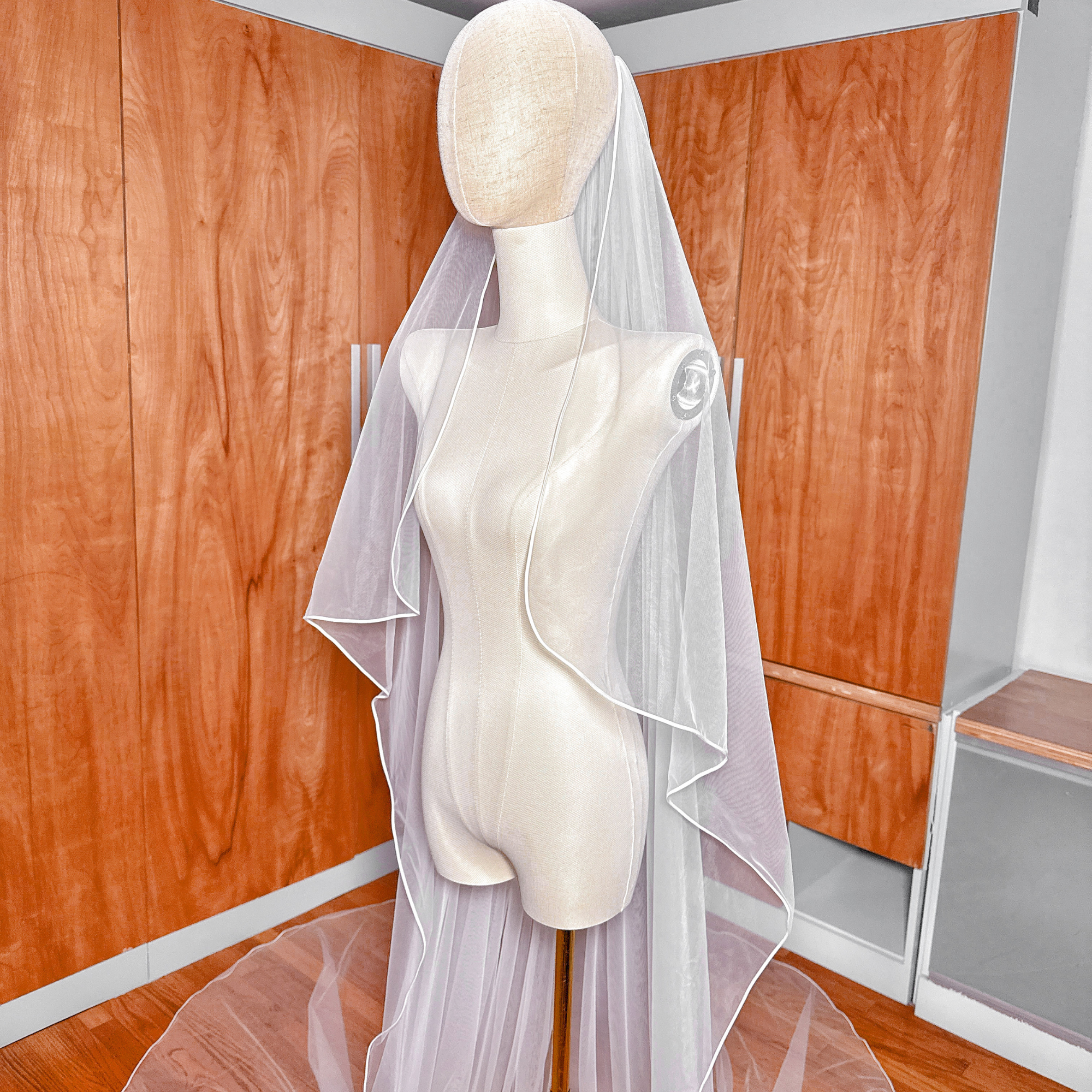 High-angle shot showing the full dramatic sweep of a cathedral length cascade wedding veil.